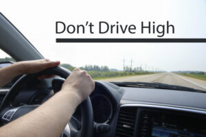 Don't Drive High written on windshield as driver looks forward