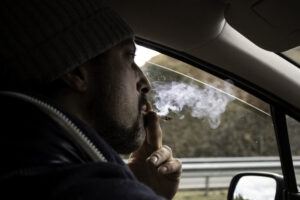 man smoking joint while driving