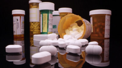 perscription bottles filled with pills and spilling out
