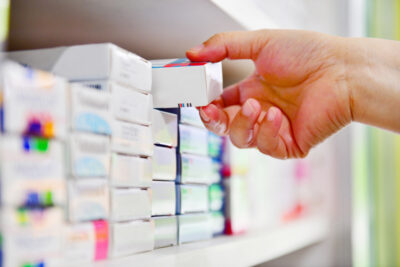 choosing box of over the counter (otc) medications off shelf